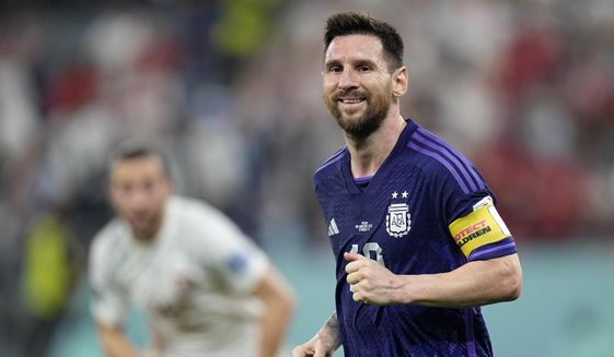 Argentina&#39;s Lionel Messi smiles during the World Cup group C soccer match between Poland and Argentina at the Stadium 974 in Doha, Qatar, Wednesday, Nov. 30, 2022. (AP Photo/Ariel Schalit)