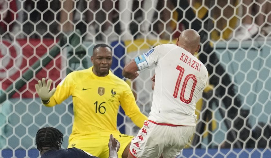 Tunisia&#39;s Wahbi Khazri, right, scores his side opening goal during the World Cup group D soccer match between Tunisia and France at the Education City Stadium in Al Rayyan , Qatar, Wednesday, Nov. 30, 2022. (AP Photo/Christophe Ena)