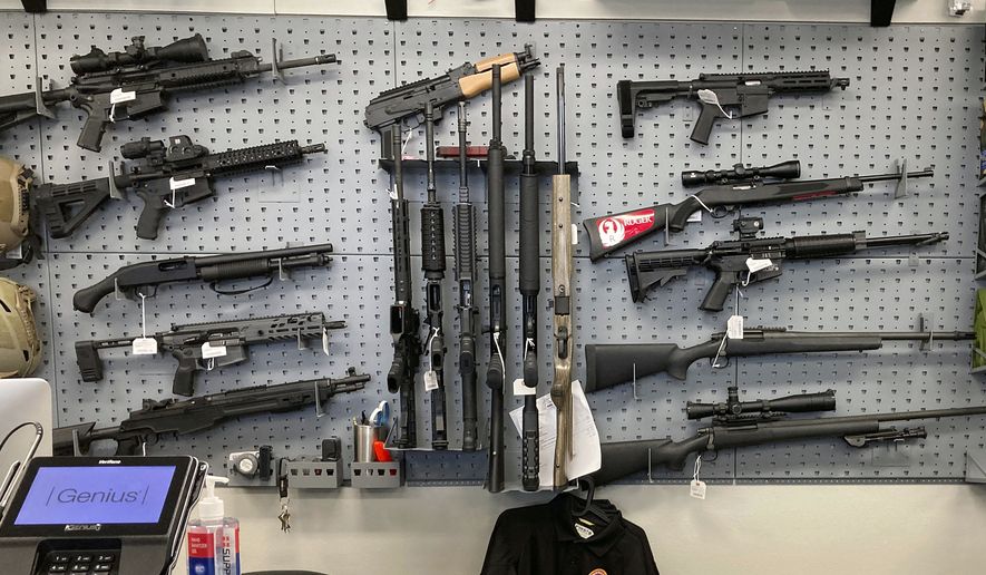 Firearms are displayed at a gun shop in Salem, Ore., on Feb. 19, 2021. (AP Photo/Andrew Selsky, File)