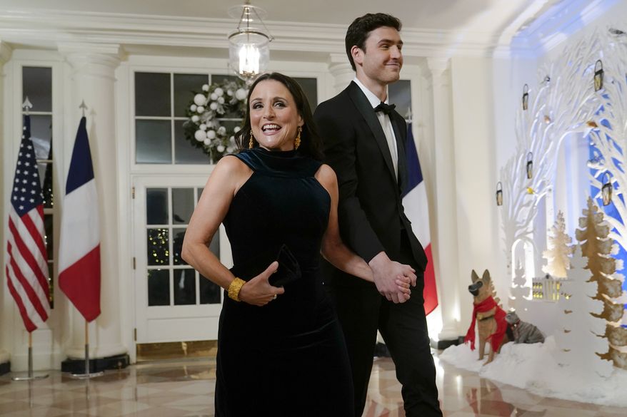 Actress Julia Louis-Dreyfus and her son actor Charlie Hall arrive for the State Dinner with President Joe Biden and French President Emmanuel Macron at the White House in Washington, Thursday, Dec. 1, 2022. (AP Photo/Susan Walsh)