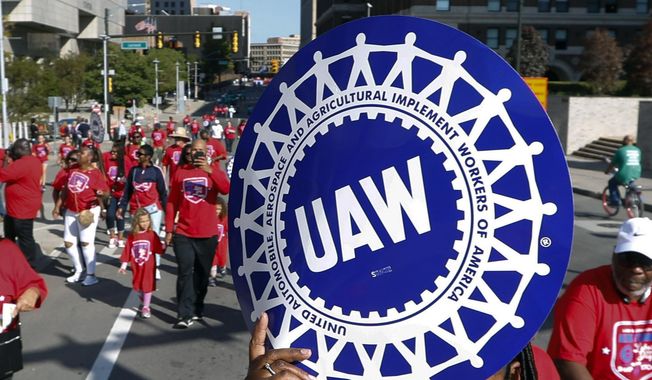 United Auto Workers members walk in the Labor Day parade in Detroit, Sept. 2, 2019. Members of the United Auto Workers union appeared on Thursday, Dec. 1, 2022, to favor replacing many of their current leaders in an election that stemmed from a federal bribery and embezzlement scandal involving former union officials. (AP Photo/Paul Sancya, File)