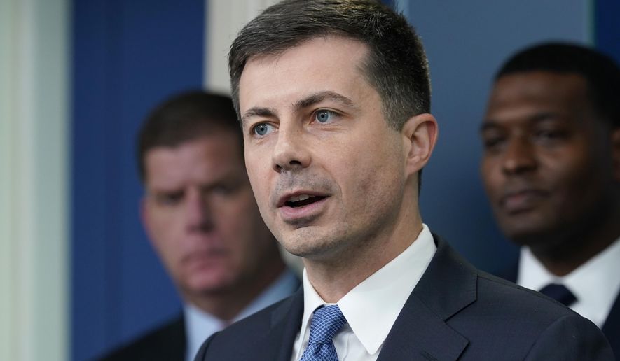 FILE - Transportation Secretary Pete Buttigieg, center, speaks during a briefing at the White House in Washington, May 16, 2022, as Labor Secretary Marty Walsh, left, and Environmental Protection Agency administrator Michael Regan, right, listen. The Biden administration is saying the U.S. economy would face a severe economic shock if senators don&#39;t pass legislation this week to avert a rail worker strike. Walsh and Buttigieg are meeting with Democratic senators Thursday, Dec. 1, to underscore that rail companies will begin shuttering operations well before a potential strike begins on Dec. 9. (AP Photo/Susan Walsh, File)