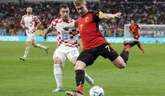 Belgium&#39;s Kevin De Bruyne, right, and Croatia&#39;s Josip Juranovic, left, fight for the ball during the World Cup group F soccer match between Croatia and Belgium at the Ahmad Bin Ali Stadium in Al Rayyan , Qatar, Thursday, Dec. 1, 2022. (AP Photo/Thanassis Stavrakis)