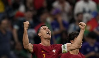 Portugal&#39;s Cristiano Ronaldo celebrates after scoring his side&#39;s opening goal during the World Cup group H soccer match between Portugal and Uruguay, at the Lusail Stadium in Lusail, Qatar, Monday, Nov. 28, 2022. (AP Photo/Aijaz Rahi)