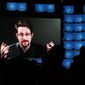 FILE - Former U.S. National Security Agency contractor Edward Snowden addresses attendees through video link at the Web Summit technology conference in Lisbon on Nov. 4, 2019. Snowden, who fled prosecution after he revealed highly classified U.S. surveillance programs, has received a Russian passport and taken the citizenship oath, his lawyer was quoted by Russian news agencies as saying Friday Dec. 2, 2022. (AP Photo/Armando Franca, File)