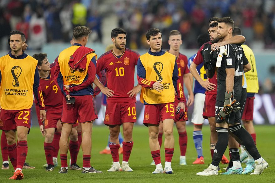 Spain players leave the pitch at the end of the World Cup group E soccer match between Japan and Spain, at the Khalifa International Stadium in Doha, Qatar, Thursday, Dec. 1, 2022. Japan won 2-1. (AP Photo/Julio Cortez)