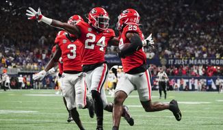 Georgia defensive back Malaki Starks (24) reacts as Georgia defensive back Christopher Smith (29) returns a blocked LSU field goal attempt for a touchdown in the first half of the Southeastern Conference Championship football game Saturday, Dec. 3, 2022 in Atlanta. (AP Photo/John Bazemore) **FILE**
