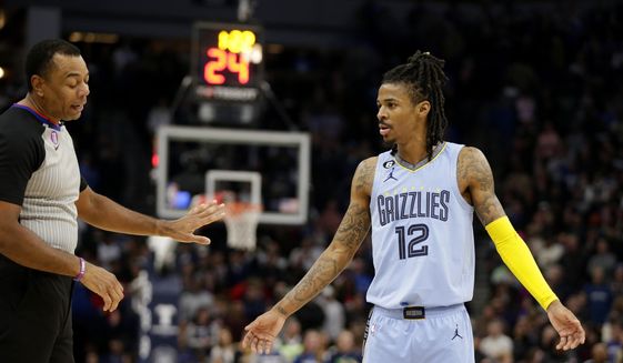 Memphis Grizzlies guard Ja Morant (12) argues with referee Karl Lane during the fourth quarter of the team&#39;s NBA basketball game against the Minnesota Timberwolves on Wednesday, Nov. 30, 2022, in Minneapolis. (AP Photo/Andy Clayton-King)