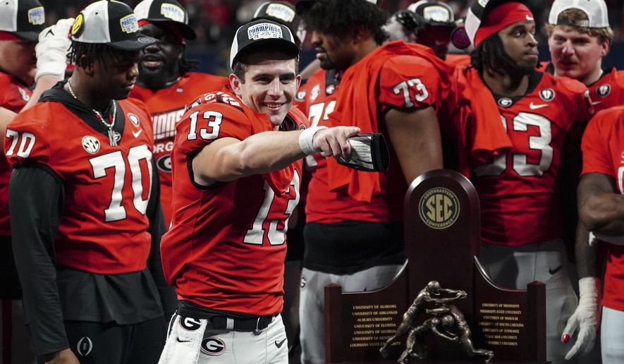 Georgia quarterback Stetson Bennett (13) gestures to the crowd during the trophy presentation the Southeastern Conference Championship football game Saturday, Dec. 3, 2022 in Atlanta. (AP Photo/John Bazemore) **FILE**