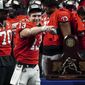 Georgia quarterback Stetson Bennett (13) gestures to the crowd during the trophy presentation the Southeastern Conference Championship football game Saturday, Dec. 3, 2022 in Atlanta. (AP Photo/John Bazemore)