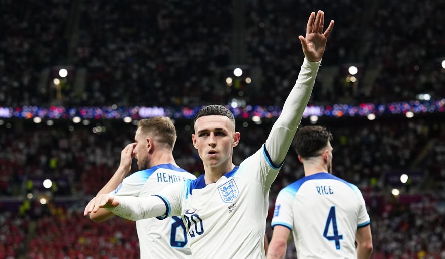 England&#39;s Phil Foden waves towards the fans after scoring his side&#39;s second goal during the World Cup group B soccer match between England and Wales, at the Ahmad Bin Ali Stadium in Al Rayyan, Qatar, Tuesday, Nov. 29, 2022. (AP Photo/Pavel Golovkin)