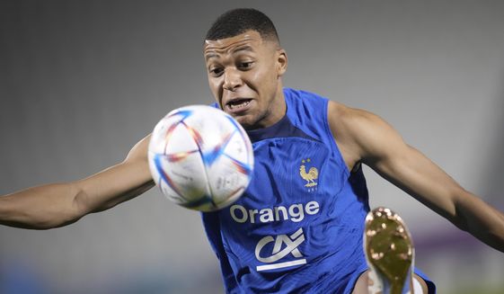 France&#39;s Kylian Mbappe controls the ball during a training session at the Jassim Bin Hamad stadium in Doha, Qatar, Friday, Dec. 2, 2022. France will play in the World Cup against Poland on Dec. 4. (AP Photo/Christophe Ena)