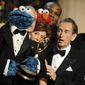 Bob McGrath, right, looks at the Cookie Monster as they accept the Lifetime Achievement Award for &#39;&quot;Sesame Street&quot; at the Daytime Emmy Awards on Aug. 30, 2009, in Los Angeles. McGrath, an actor, musician and children’s author widely known for his portrayal of one of the first regular characters on the children’s show “Sesame Street” has died at the age of 90.  McGrath’s passing was confirmed by his family who posted on his Facebook page on Sunday, Dec. 4, 2022.   (AP Photo/Chris Pizzello, File)