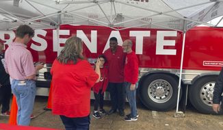 Republican U.S. Senate nominee Herschel Walker, a former University of Georgia football star, greets Georgia football fans Saturday, Dec. 3, 2022 before the Bulldogs&#39; SEC Championship victory over the LSU Tigers in Atlanta. Walker faces Sen. Raphael Warnock, a Democrat, in a Tuesday runoff. Walker and Georgia Republicans, especially, have tried to capitalize on sports and college loyalties to connect with voters. (AP Photo/Bill Barrow)
