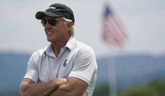 FILE - LIV Golf CEO and Commissioner Greg Norman watches play during the pro-am of the Bedminster Invitational LIV Golf tournament in Bedminster, N.J., July 28, 2022. Rory McIlroy thought his differences with Norman over a Saudi-funded golf league had been patched up. That changed when Norman accused him of being “brainwashed” by golf&#39;s ruling brass. “I thought, You know what? I&#39;m going to make it my business now to be as much of a pain in his arse as possible,&#39;” McIlroy said in a lengthy interview in the Sunday Independent in Ireland. (AP Photo/Seth Wenig, File)