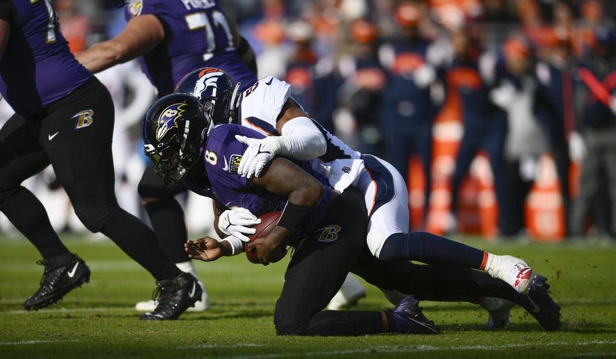 Baltimore Ravens quarterback Lamar Jackson (8) is sacked by Denver Broncos linebacker Jonathon Cooper (53), in the first half of an NFL football game, Sunday, Dec. 4, 2022, in Baltimore. (AP Photo/Nick Wass)