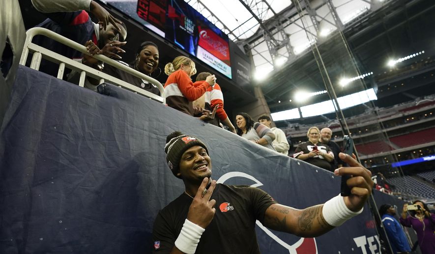 Cleveland Browns quarterback Deshaun Watson takes a selfie with fans before of an NFL football game between the Cleveland Browns and Houston Texans in Houston, Sunday, Dec. 4, 2022,. (AP Photo/Eric Christian Smith)
