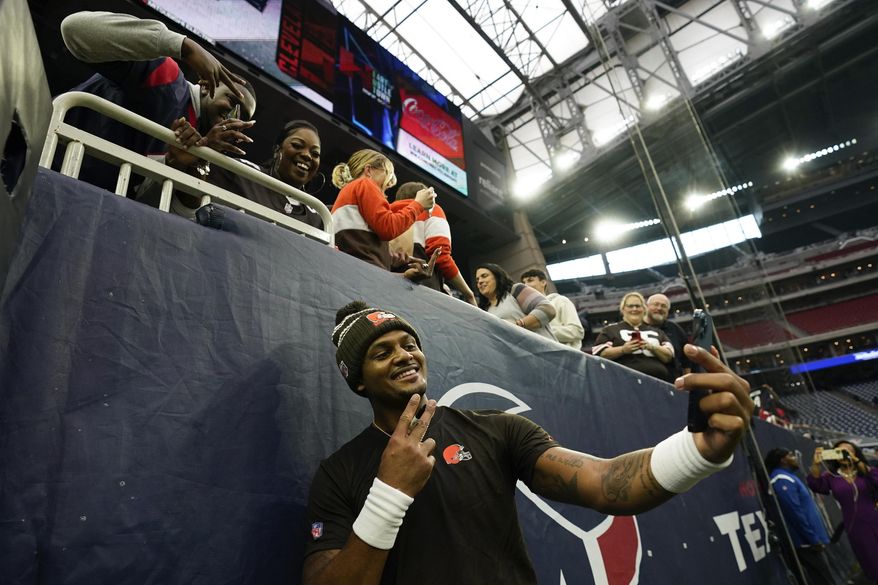 Cleveland Browns quarterback Deshaun Watson takes a selfie with fans before of an NFL football game between the Cleveland Browns and Houston Texans in Houston, Sunday, Dec. 4, 2022,. (AP Photo/Eric Christian Smith)