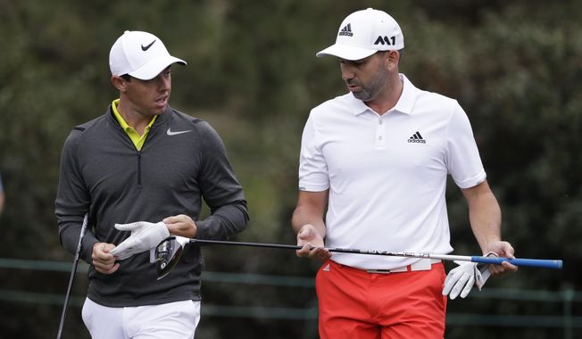 Rory McIlroy, left, of Northern Ireland, and Sergio Garcia, of Spain, walk up the 15th fairway during a practice round for the Masters golf tournament April 5, 2017, in Augusta, Ga. McIlroy, in a lengthy interview in the Sunday Independent in Ireland, says his close friendship with Garcia ended over a testy text exchange at the U.S. Open. (AP Photo/Matt Slocum, File)