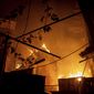 A house burns after a Russian attack in Kherson, Ukraine, Saturday, Dec. 3, 2022. (AP Photo/Evgeniy Maloletka)
