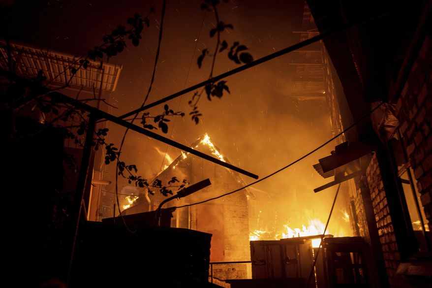 A house burns after a Russian attack in Kherson, Ukraine, Saturday, Dec. 3, 2022. (AP Photo/Evgeniy Maloletka)