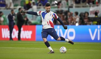 France&#39;s goalkeeper Hugo Lloris kicks the ball during warm up ahead of the World Cup round of 16 soccer match between France and Poland, at the Al Thumama Stadium in Doha, Qatar, Sunday, Dec. 4, 2022. (AP Photo/Moises Castillo)