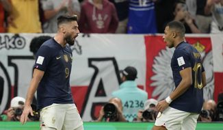 France&#39;s Olivier Giroud celebrates after scoring his side&#39;s first goal with France&#39;s Kylian Mbappe during the World Cup round of 16 soccer match between France and Poland, at the Al Thumama Stadium in Doha, Qatar, Sunday, Dec. 4, 2022. (AP Photo/Moises Castillo)