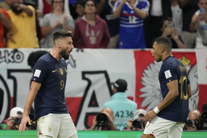 France&#x27;s Olivier Giroud celebrates after scoring his side&#x27;s first goal with France&#x27;s Kylian Mbappe during the World Cup round of 16 soccer match between France and Poland, at the Al Thumama Stadium in Doha, Qatar, Sunday, Dec. 4, 2022. (AP Photo/Moises Castillo)
