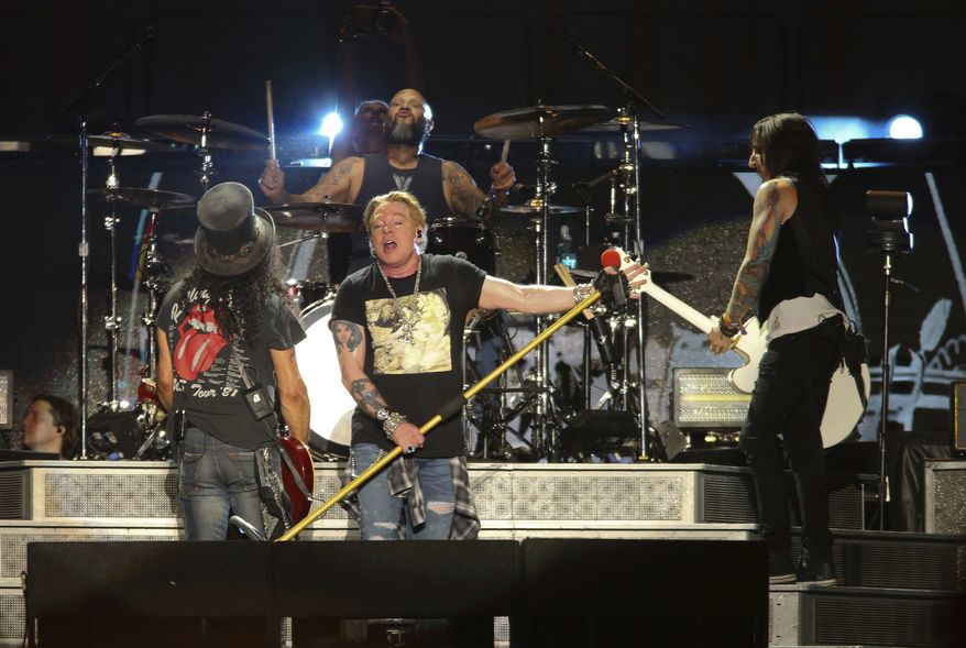 Guns N&#x27; Roses&#x27; Axl Rose, center, Slash, left, and Richard Fortus perform on the first weekend of the Austin City Limits Music Festival at Zilker Park in Austin, Texas, on Friday, Oct. 4, 2019. (Photo by Jack Plunkett/Invision/AP) **FILE**