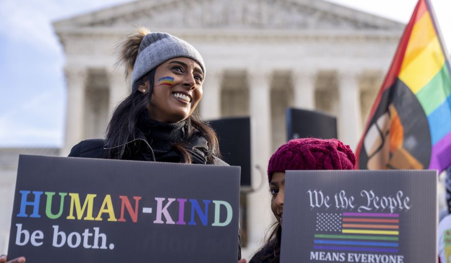 Pro-gay rights supporter Amrita Bhowmick and her daughter Maya, 10, stand outside the Supreme Court in Washington, Monday, Dec. 5, 2022. The Supreme Court is hearing the case of a Christian graphic artist who objects to designing wedding websites for gay couples, that&#x27;s the latest clash of religion and gay rights to land at the highest court. (AP Photo/Andrew Harnik)