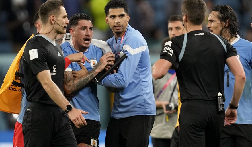 Uruguay&#39;s Jose Gimenez argues with the referee at the end of a World Cup group H soccer match against Ghana at the Al Janoub Stadium in Al Wakrah, Qatar, Friday, Dec. 2, 2022. (AP Photo/Darko Vojinovic)