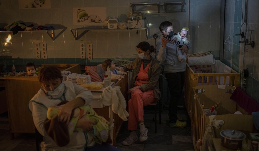 Hospital staff take care of orphaned children at the children&#39;s regional hospital maternity ward in Kherson, southern Ukraine, Tuesday, Nov. 22, 2022.  Throughout the war in Ukraine, Russian authorities have been accused of deporting Ukrainian children to Russia or Russian-held territories to raise them as their own. At least 1,000 children were seized from schools and orphanages in the Kherson region during Russia’s eight-month occupation of the area, their whereabouts still unknown. (AP Photo/Bernat Armangue)