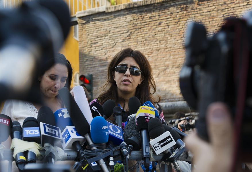 Italian communications expert Francesca Chaouqui talks to journalists on July 7, 2016, after a Vatican court convicted her and a Vatican monsignor for having conspired to pass documents to two Italian journalists.  A Vatican trial into a money-losing investment has been jolted by revelations that a key prosecution witness was apparently manipulated into changing his story and cooperating with prosecutors. (AP Photo/Domenico Stinellis, File)