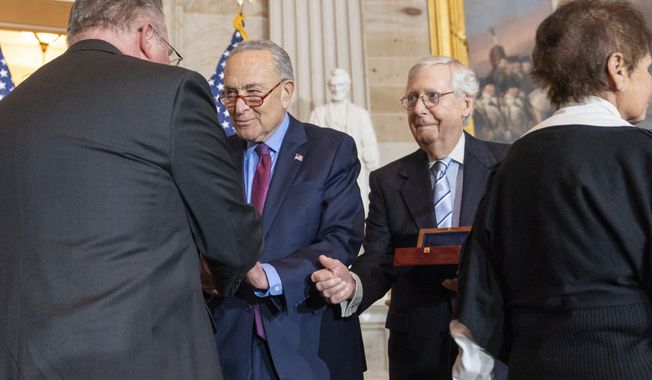 Craig Sicknick, left, brother of slain U.S. Capitol Police Officer Brian Sicknick, is greeted by Senate Majority Leader Chuck Schumer of N.Y., with Senate Minority Leader Mitch McConnell of Ky., and Gladys Sicnick, right, the mother of slain U.S. Capitol Police Officer Brian Sicknick, during a Congressional Gold Medal ceremony honoring law enforcement officers who defended the U.S. Capitol on Jan. 6, 2021, in the U.S. Capitol Rotunda in Washington, Tuesday, Dec. 6, 2022. The members of the Sicknick family declined to shake hands with McConnell and House Minority Leader Kevin McCarthy of Calif. (AP Photo/Alex Brandon)