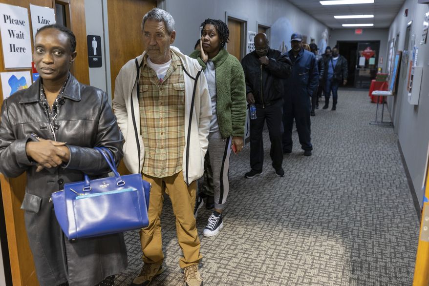 People wait in line to vote in Georgia's runoff election for U.S Senate at the Calvary Baptist Church in Austell, Ga., Tuesday morning, Dec. 6, 2022. (Steve Schaefer/Atlanta Journal-Constitution via AP)