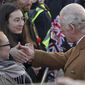 Britain&#39;s King Charles III, right, greets members of the public as he arrives for a visit to Luton Town Hall, where he is meeting community leaders and voluntary organisations, in Luton, England, Tuesday, Dec. 6, 2022. (Yui Mok/PA via AP)