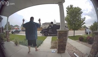 In this image from video provided by Leslie Bowman, Anderson Lee Aldrich surrenders to police at a home where his mother, Laura Voepel, was renting a room in Colorado Springs, Colo., on June 18, 2021. According to sealed law enforcement documents verified by The Associated Press, Aldrich&#39;s actions brought SWAT teams and the bomb squad to the normally quiet neighborhood, forced the grandparents to flee for their lives and prompted the evacuation of 10 nearby homes to escape a possible bomb blast. (Leslie Bowman via AP)