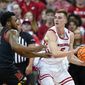 Wisconsin&#39;s Tyler Wahl (5) looks to pass the ball as Maryland&#39;s Donta Scott (24) defends during the first half of an NCAA college basketball game Tuesday, Dec. 6, 2022, in Madison, Wis. (AP Photo/Andy Manis)