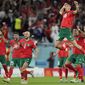 Morocco&#x27;s Jawad El Yamiq, top, celebrates with team mates after the penalty shootout at the World Cup round of 16 soccer match between Morocco and Spain, at the Education City Stadium in Al Rayyan, Qatar, Tuesday, Dec. 6, 2022. (AP Photo/Luca Bruno)