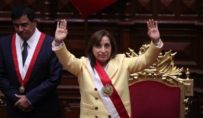 Former Vice President Dina Boluarte acknowledges lawmakers after she was sworn in as president in Lima, Peru, Wednesday, Dec. 7, 2022. Behind is Congress President Jose Williams. Peru&#x27;s Congress voted to remove President Pedro Castillo from office Wednesday and replace him with the vice president, shortly after Castillo tried to dissolve the legislature ahead of a scheduled vote to remove him. (AP Photo/Guadalupe Pardo)