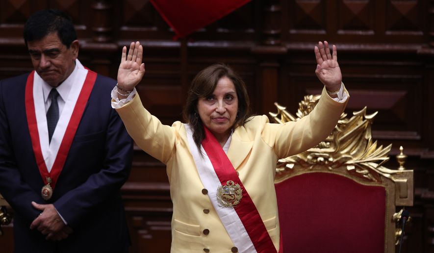Former Vice President Dina Boluarte acknowledges lawmakers after she was sworn in as president in Lima, Peru, Wednesday, Dec. 7, 2022. Behind is Congress President Jose Williams. Peru&#39;s Congress voted to remove President Pedro Castillo from office Wednesday and replace him with the vice president, shortly after Castillo tried to dissolve the legislature ahead of a scheduled vote to remove him. (AP Photo/Guadalupe Pardo)