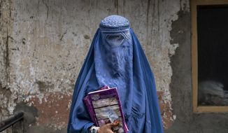 Arefeh 40-year-old, an Afghan woman leaves an underground school, in Kabul, Afghanistan, Saturday, July 30, 2022. (AP Photo/Ebrahim Noroozi, File)