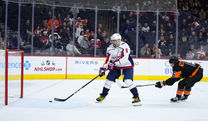 Washington Capitals&#x27; Alex Ovechkin scores a goal as Philadelphia Flyers&#x27; Travis Sanheim defends during the third period of an NHL hockey game, Wednesday, Dec. 7, 2022, in Philadelphia. (AP Photo/Matt Slocum)