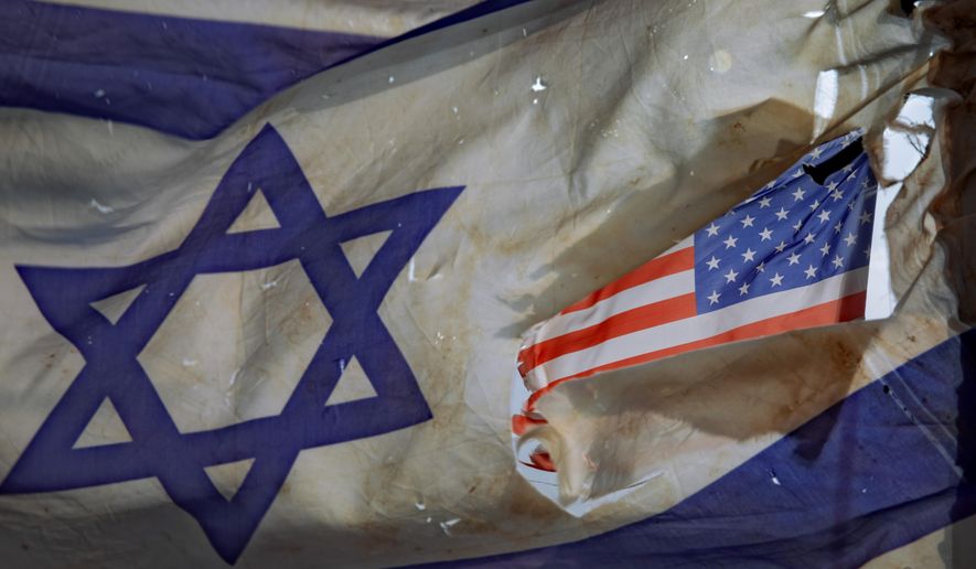 A U.S. flag is seen through a hole torn in an Israel national flag, as they wave in the wind at a horse ranch, near the southern Israeli town of Sderot, Friday, Nov. 20, 2020. Major Jewish American organizations, traditionally a bedrock of support for Israel, have expressed alarm over the presumptive government&#x27;s far-right character. Given American Jews&#x27; predominantly liberal political views and affinity for the Democratic Party, these misgivings could have a ripple effect in Washington and further deepen what has become a partisan divide over support for Israel. (AP Photo/Oded Balilty, File)