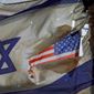 A U.S. flag is seen through a hole torn in an Israel national flag, as they wave in the wind at a horse ranch, near the southern Israeli town of Sderot, Friday, Nov. 20, 2020. Major Jewish American organizations, traditionally a bedrock of support for Israel, have expressed alarm over the presumptive government&#x27;s far-right character. Given American Jews&#x27; predominantly liberal political views and affinity for the Democratic Party, these misgivings could have a ripple effect in Washington and further deepen what has become a partisan divide over support for Israel. (AP Photo/Oded Balilty, File)