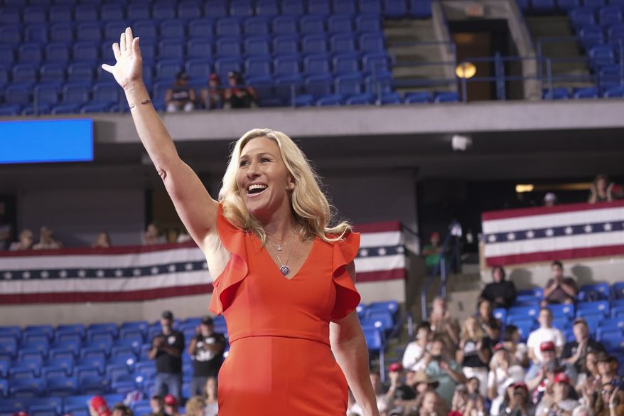 Rep. Marjorie Taylor Greene, R-Ga., waves at supporters as she arrives to speak ahead of former President Donald Trump at a rally in Wilkes-Barre, Pa., Saturday, Sept. 3, 2022. (AP Photo/Mary Altaffer)