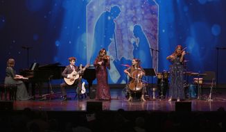 Violinist Jenny Oaks Baker (center) performs with (from left) daughter Hannah Jean Baker, pianist; son Matthew D. Baker, guitar; daughter Sarah Noelle Baker, cello; and daughter Laura June Dickson, violin, at &quot;Joy to the World&quot; concert in Salt Lake City on Dec. 3. (Photo courtesy of Jenny Oaks Baker, used with permission)