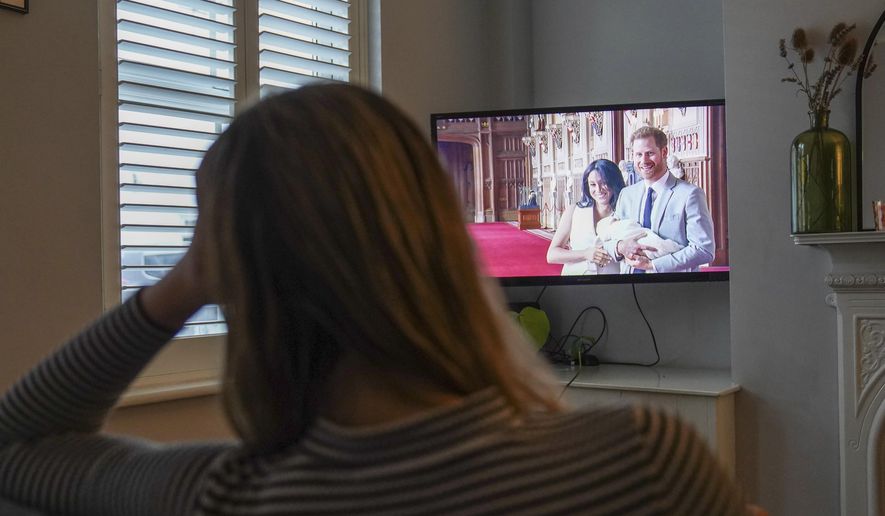 Georgia watches the Duke and Duchess of Sussex&#x27;s controversial documentary being aired on Netflix at her home in Warwick, Britain, Thursday, Dec. 8, 2022. Britain’s monarchy is bracing for more bombshells to be lobbed over the palace gates as Netflix releases the first three episodes of a new series. The show “Harry &amp;amp; Meghan” promises to tell the “full truth” about Prince Harry and his wife Meghan’s estrangement from the royal family. The series debuted Thursday. (Jacob King/PA via AP)