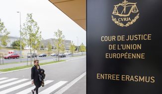 In this photo taken on Oct. 5, 2015, a woman walks by the entrance to the European Court of Justice in Luxembourg. The European Union’s top court says Google has to delete search results about people in Europe if they can prove that the information is clearly wrong. People in Europe have the right to ask search engines to delete links to outdated or embarrassing information about themselves, even if it is true, under a principle known as “right to be forgotten.” (AP Photo/Geert Vanden Wijngaert) ** FILE **