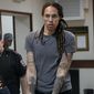 WNBA star and two-time Olympic gold medalist Brittney Griner is escorted from a courtroom after a hearing in Khimki just outside Moscow, on Aug. 4, 2022. Russia has freed WNBA star Brittney Griner on Thursday in a dramatic high-level prisoner exchange, with the U.S. releasing notorious Russian arms dealer Viktor Bout. (AP Photo/Alexander Zemlianichenko, File)